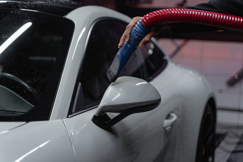 Photo by Tima Miroshnichenko A Person Cleaning a White Car