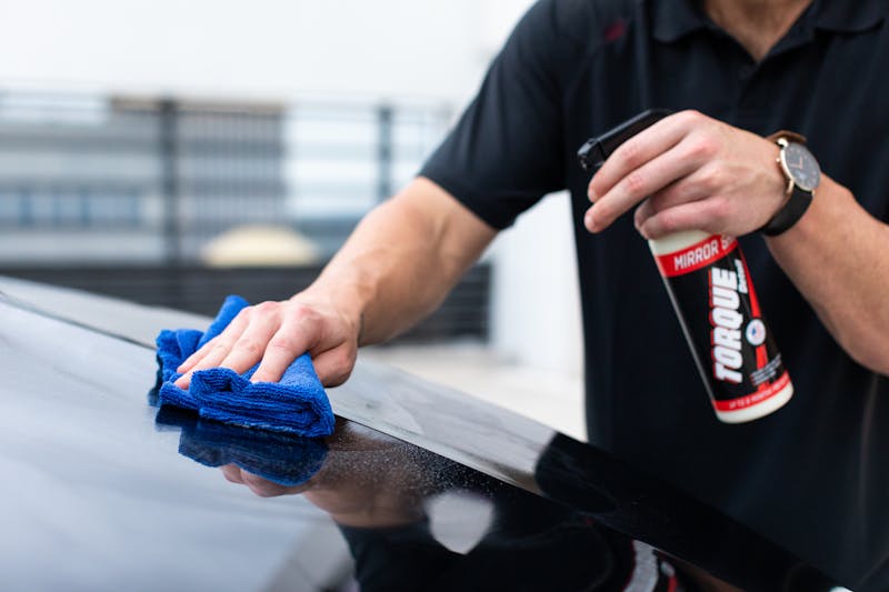 Photo by Torque Detail A Person in Black Shirt Cleaning Black Car
